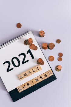 A 2021 calendar page with coins and scrabble pieces spelling 'SMALL BUSINESS'.