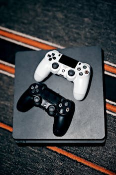Black and white game controllers placed on a console, symbolizing modern gaming technology.