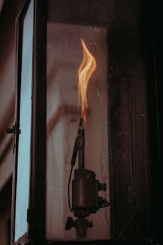 Capture of a solitary flame in a vintage lantern, evoking industrial energy and moody urban vibes.