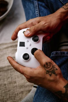 Close-up of hands holding a gaming controller, focused on gameplay.