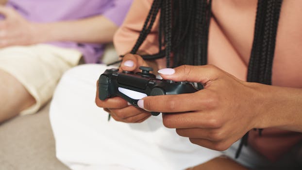 Close-up shot of a person holding a wireless gaming controller indoors.