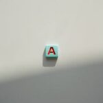 Single letter 'A' tile on a light background, casting a shadow.